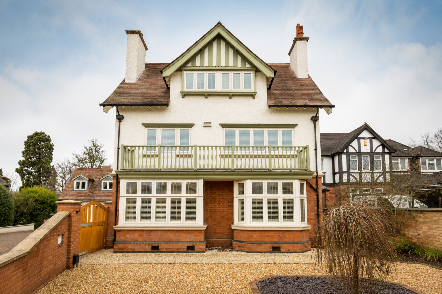 Front elevation of a white gabled house with green timber framing and brick wall, Lawnside