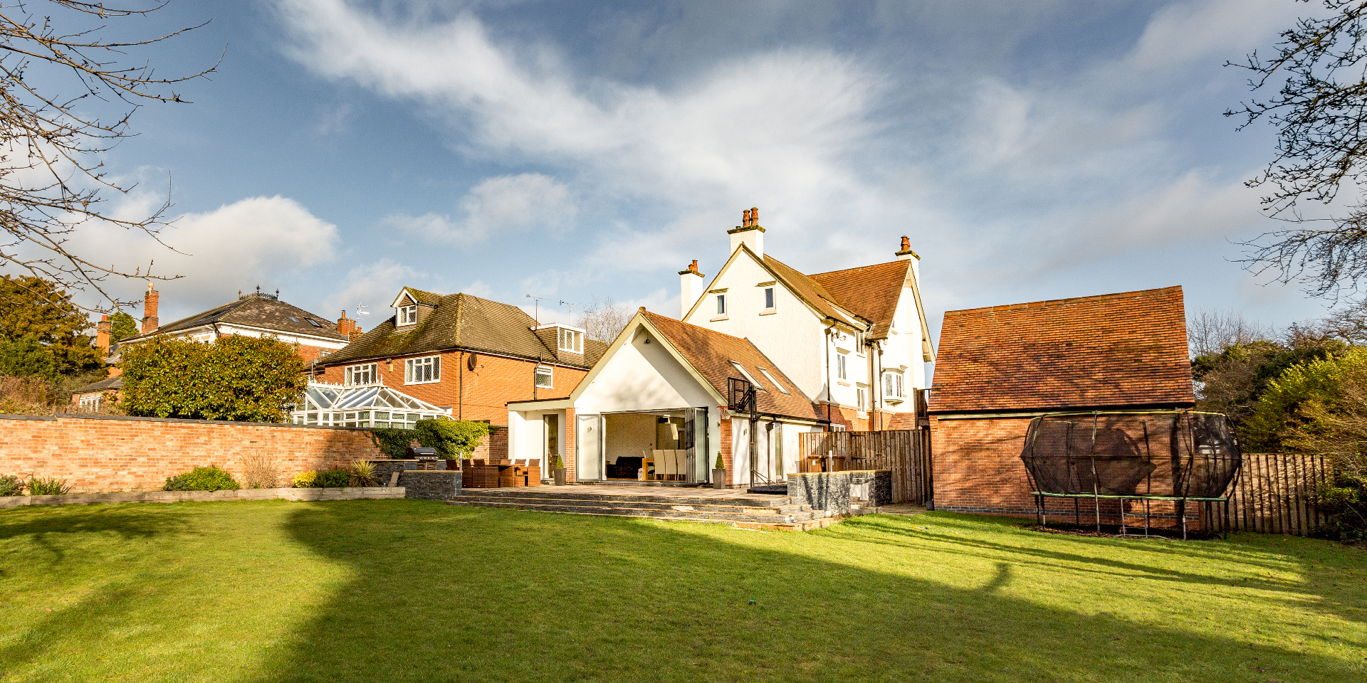 Rear garden view of the Edwardian villa with contemporary rendered extension